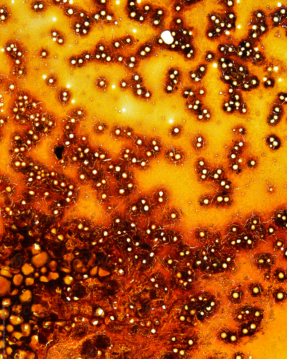 macro of grease residue in bottom of a glass broiling pan