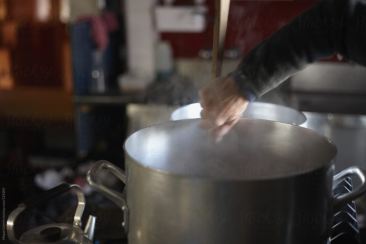 Cook stirring in the hot soup and big pot