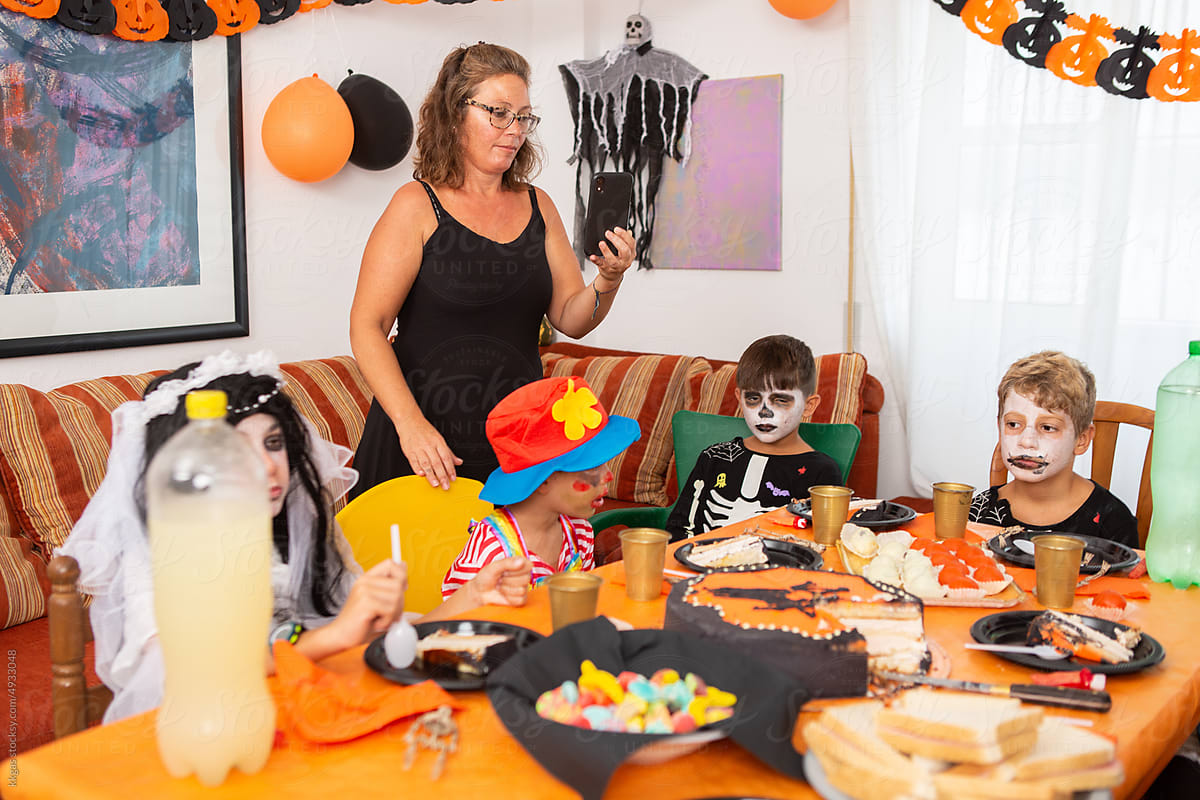 Parent films kids  in fancy dress costumes for halloween party