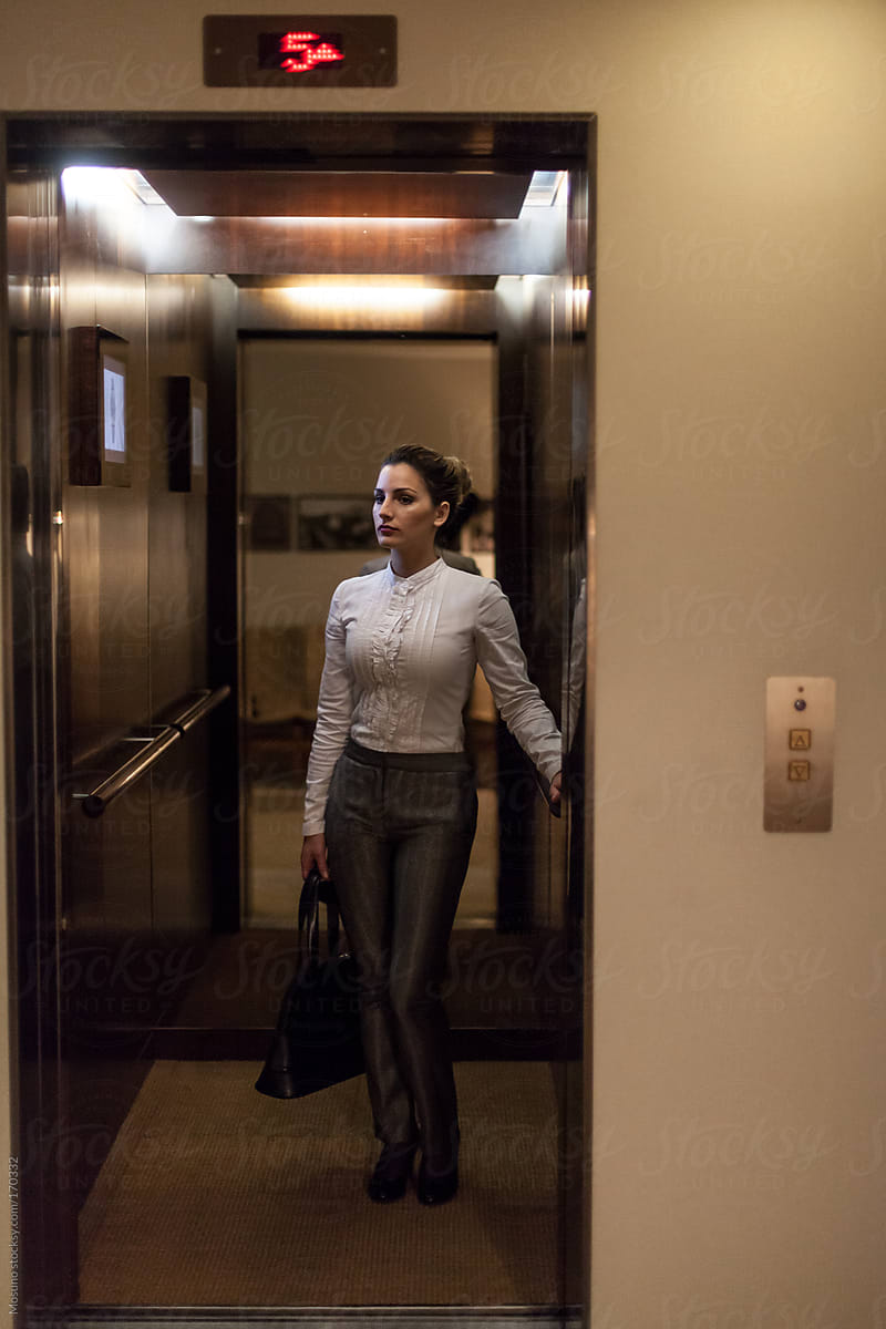 Businesswoman Standing in a Hotel Elevator