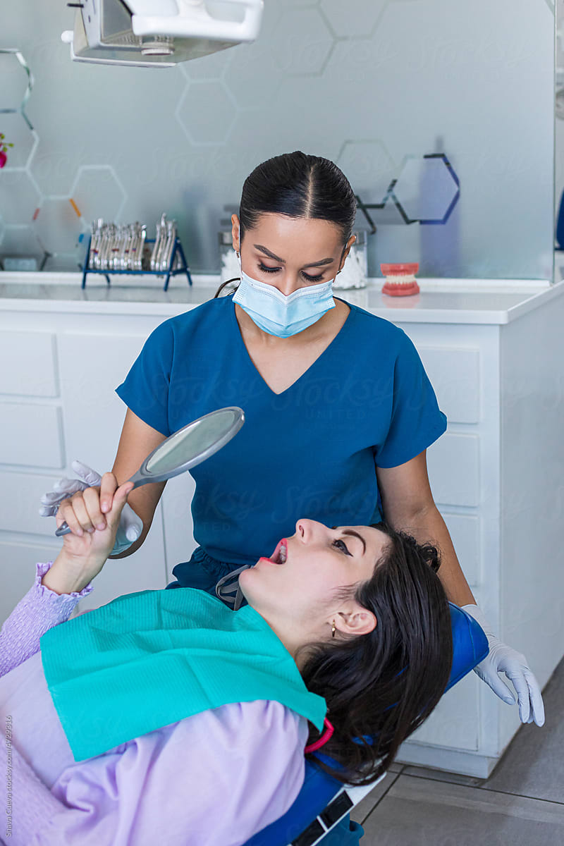 Dental patient wearing a dental bib looking in the mirror