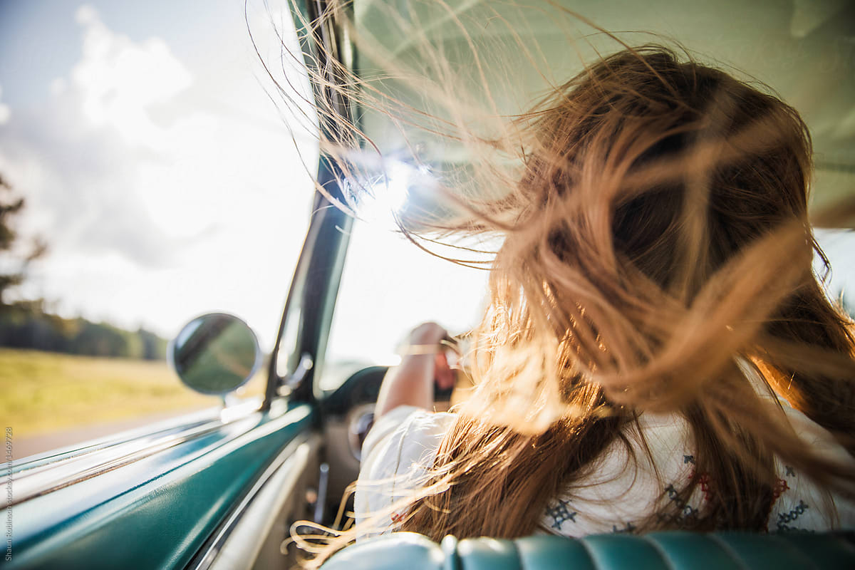 Girl Driving With Her Hair Blowing In The Wind From The Window By Stocksy Contributor Shaun