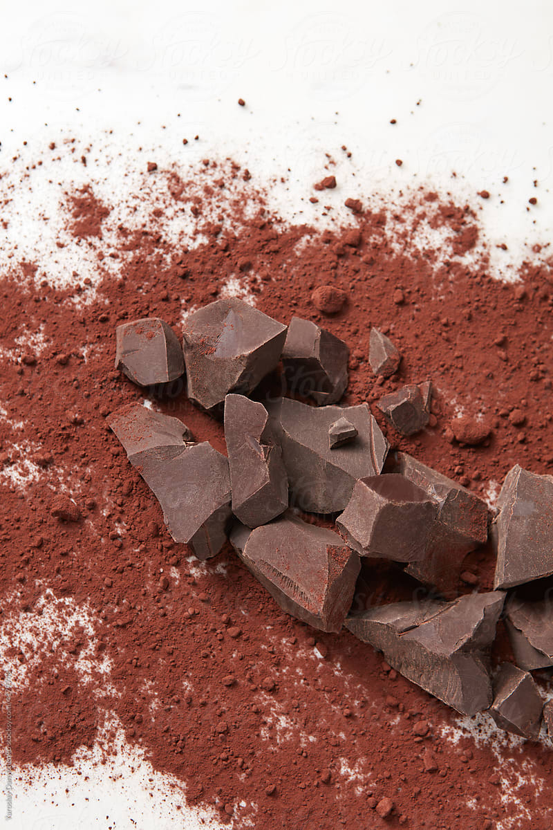 Dark chocolate and cocoa powder on background