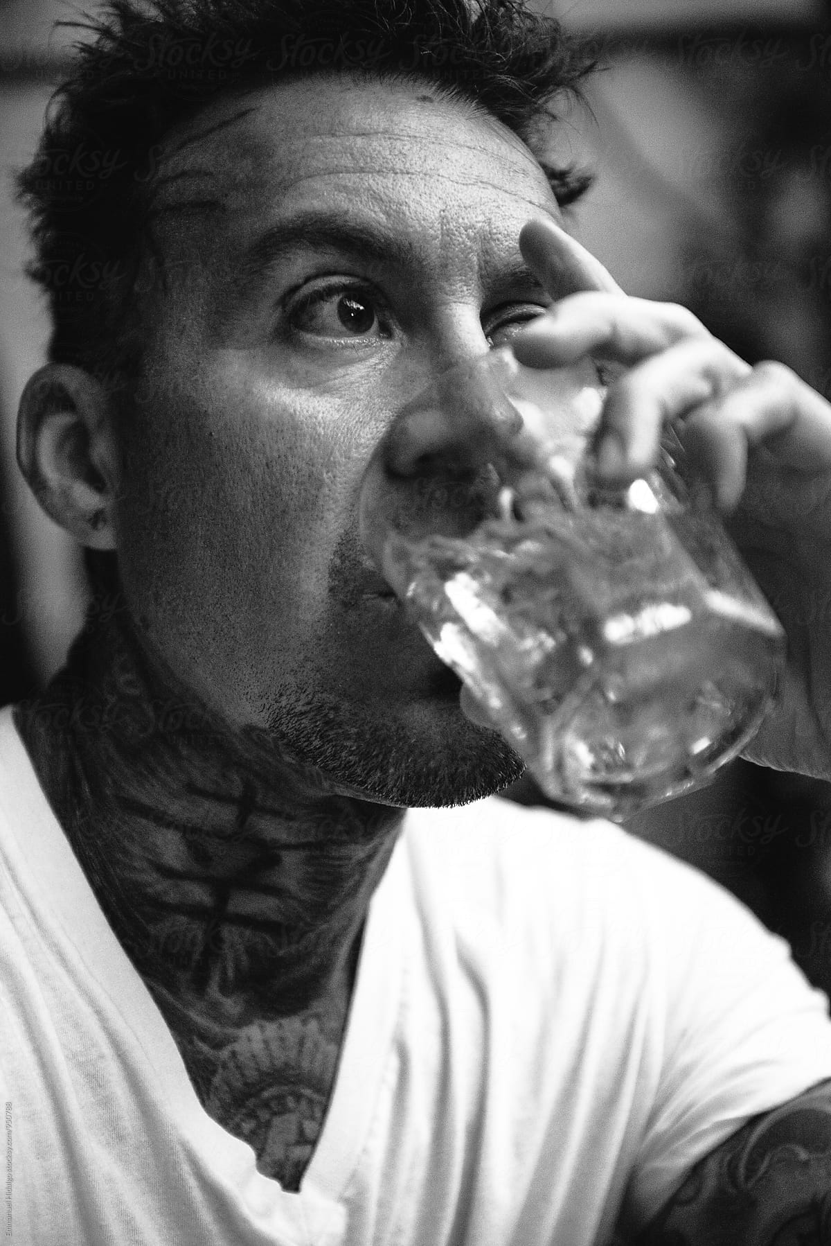Man having a strong drink - in black and white