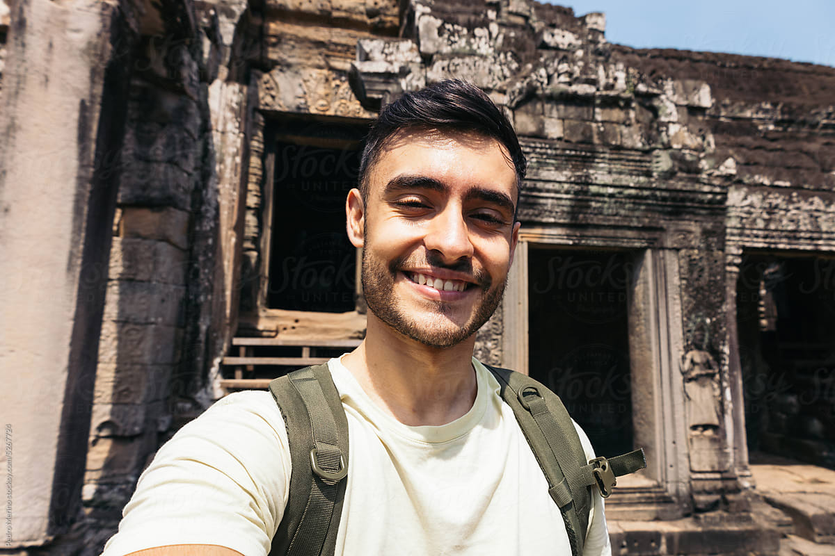 Happy traveler man in Angkor