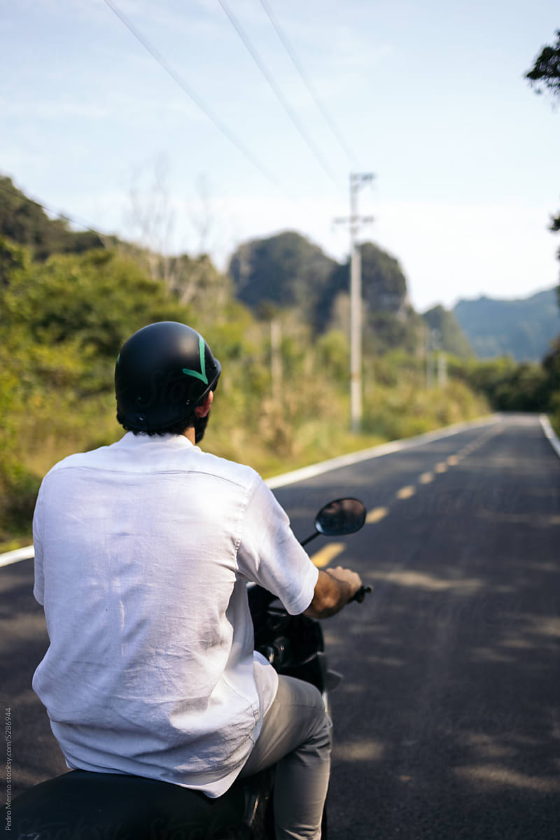 Tourist touring the roads of Southeast Asia on a scooter