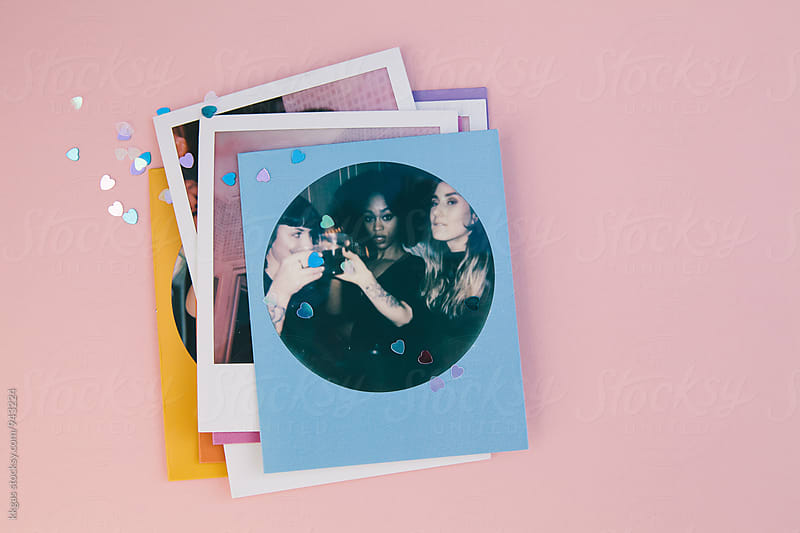 Polaroid print of best friends on a pink background with heart confetti