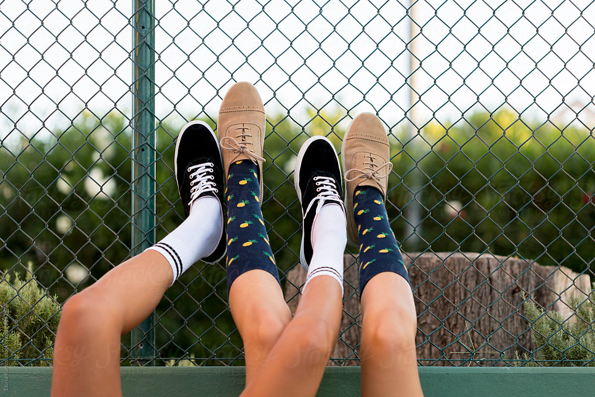 Crossed teenagers legs with socks lying on the floor