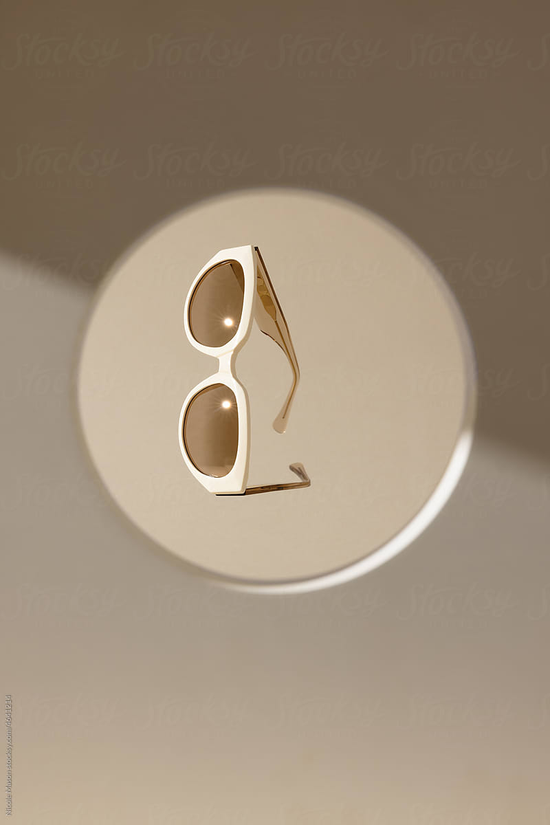 sunglasses floating in circular frame