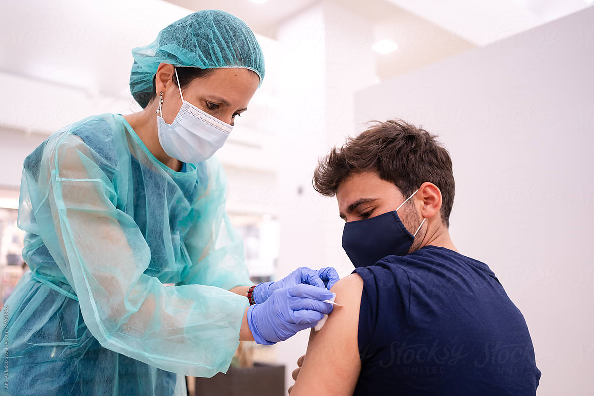 Young Teen And Nurse During COVID-19 Vaccination.