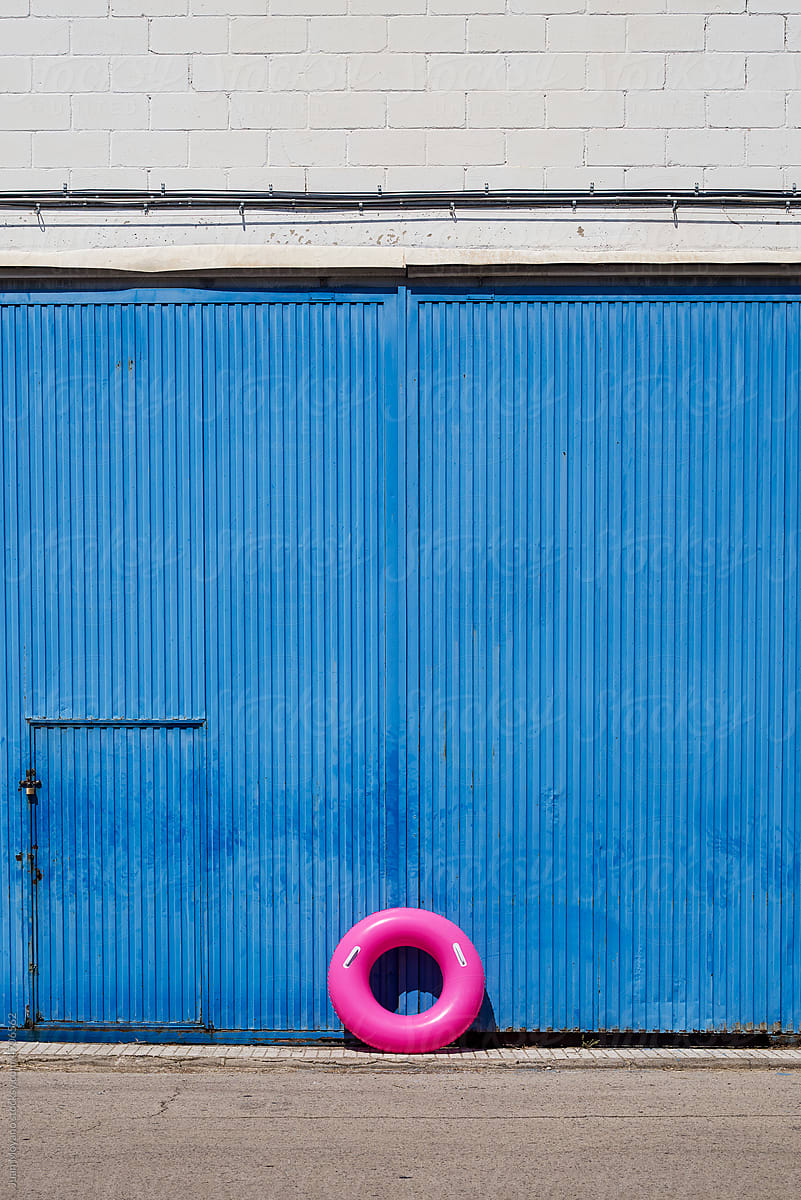 swim ring leaning on the door of a warehouse