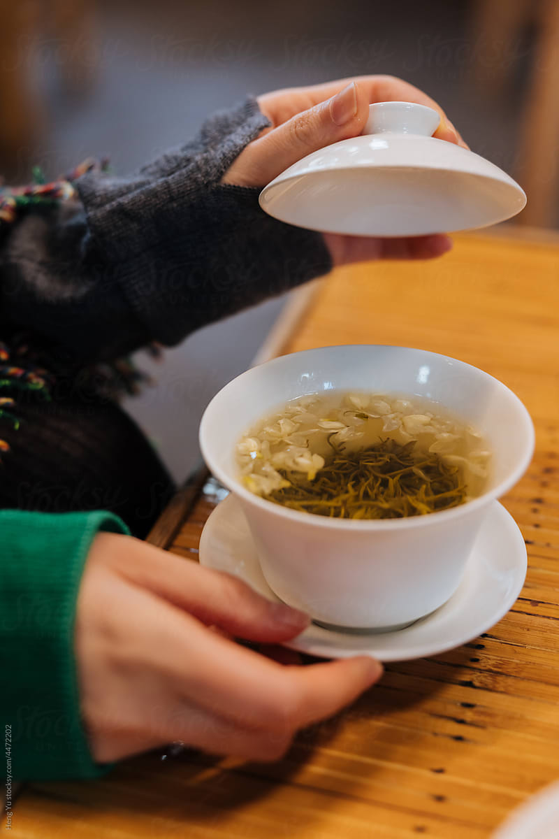 Woman handing traditional Chinese tea