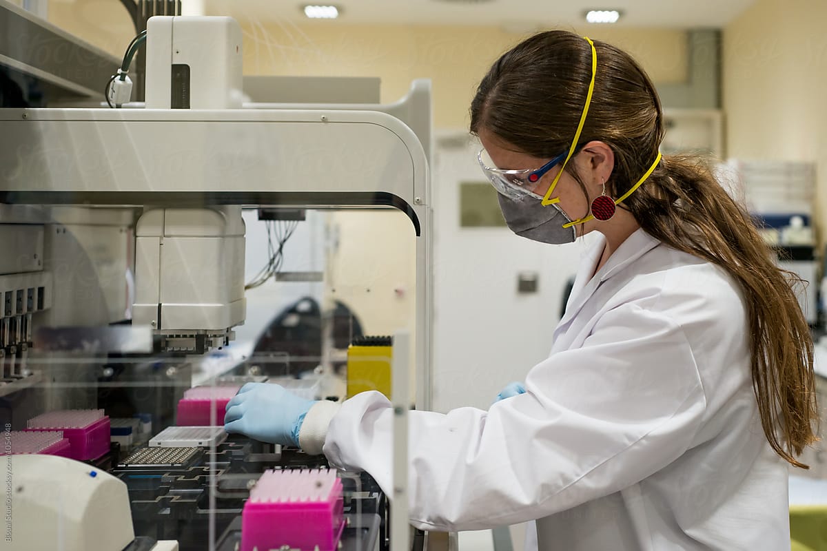 Female scientist working with a genome sequencing machine in a DNA laboratory