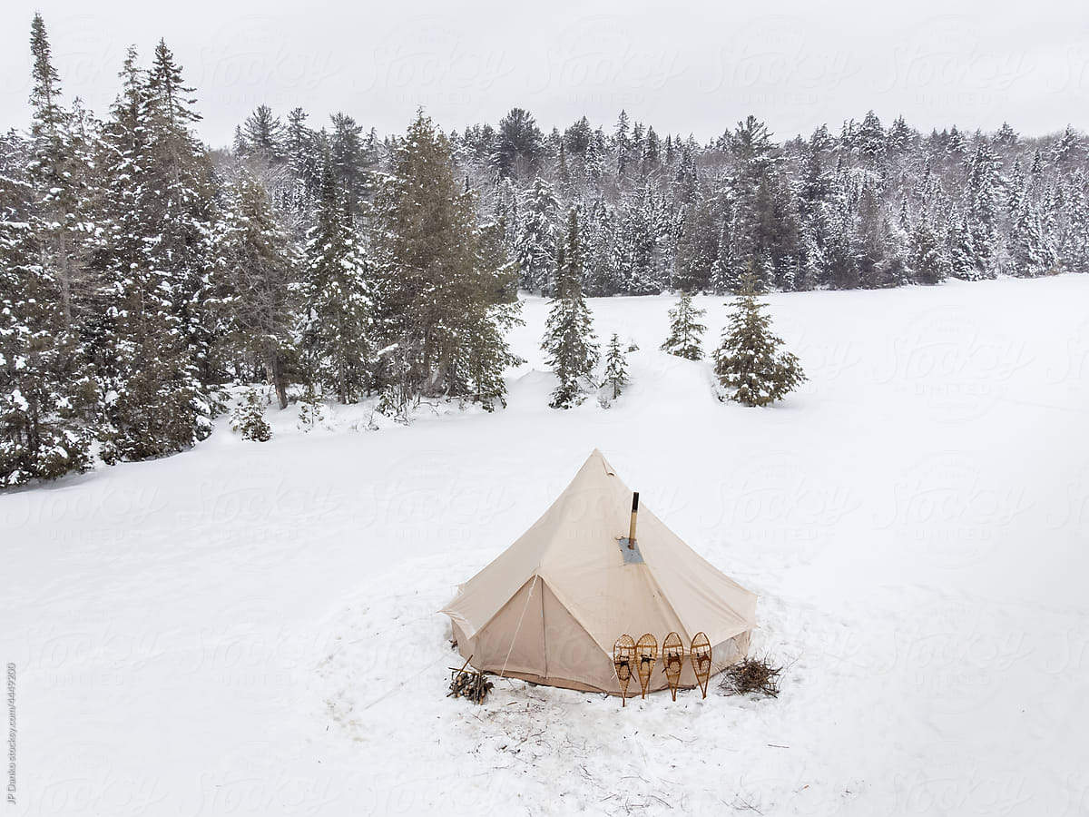 Isolated Traditional Winter Tent Campsite with Snowshoes