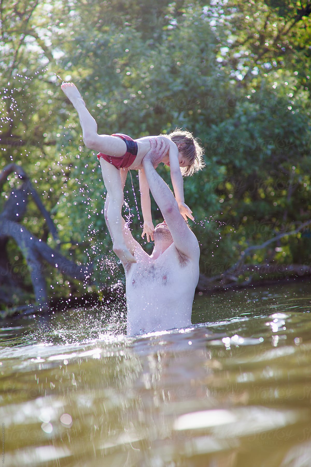 Dad raising his son from the water