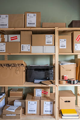 Young Logistic Manager Organizing Boxes In Storage by Stocksy Contributor  Milles Studio - Stocksy