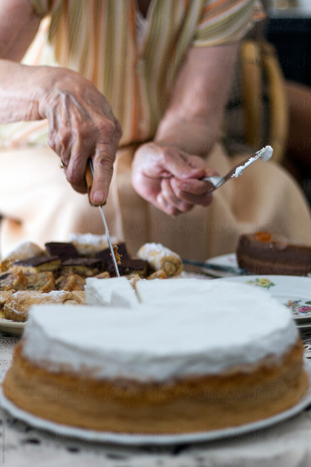 Old woman cutting cake
