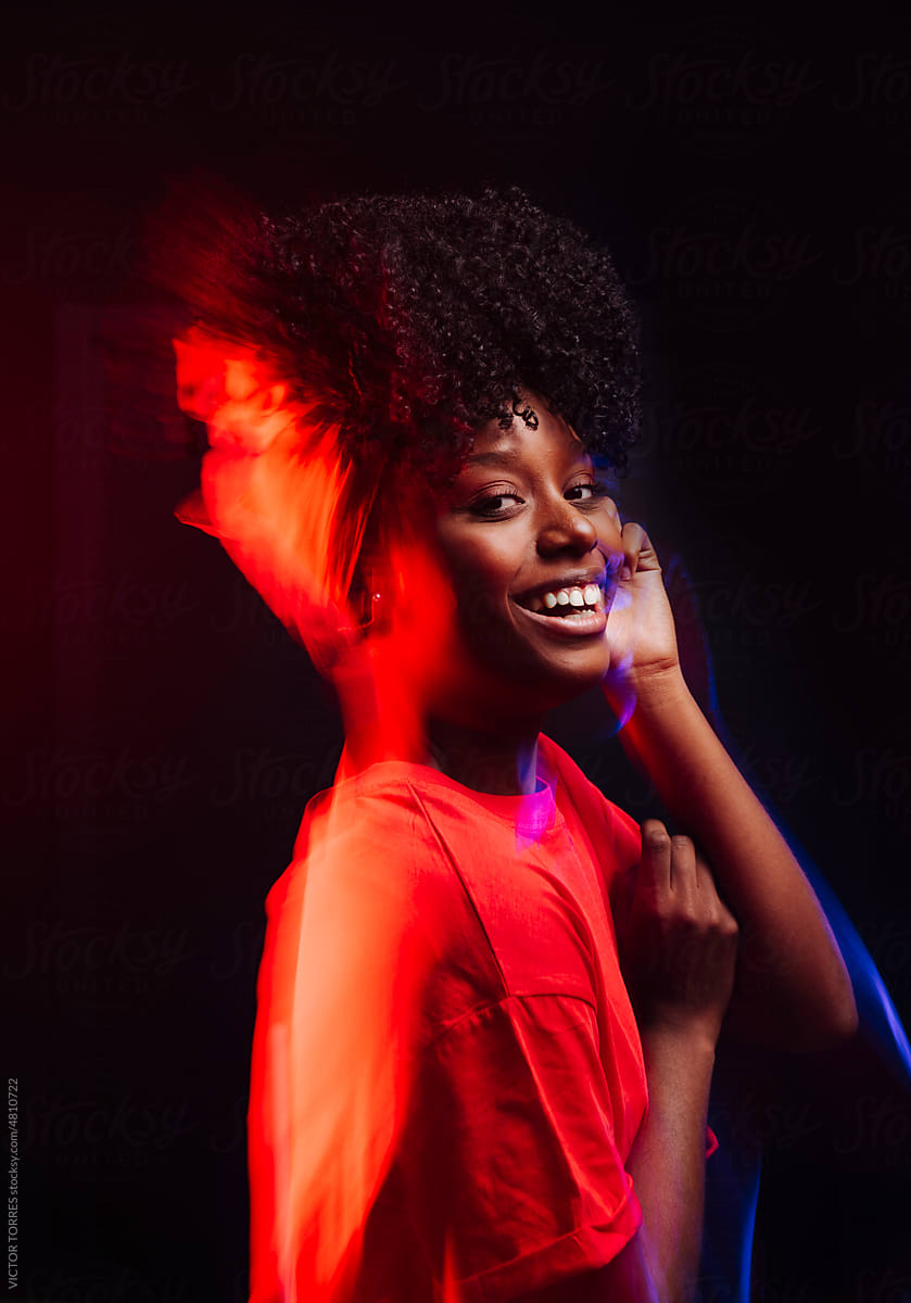 Cheerful black woman in red dress