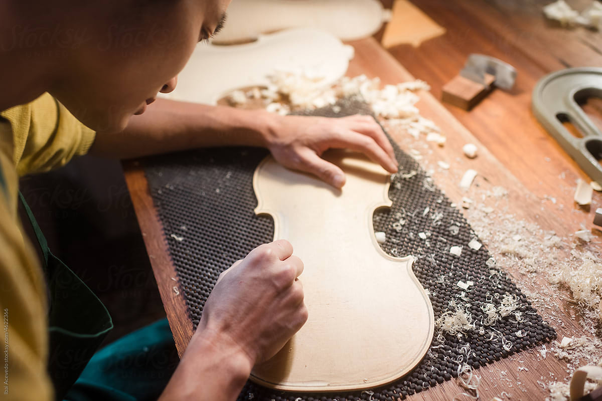 Focused luthier polishing violin template