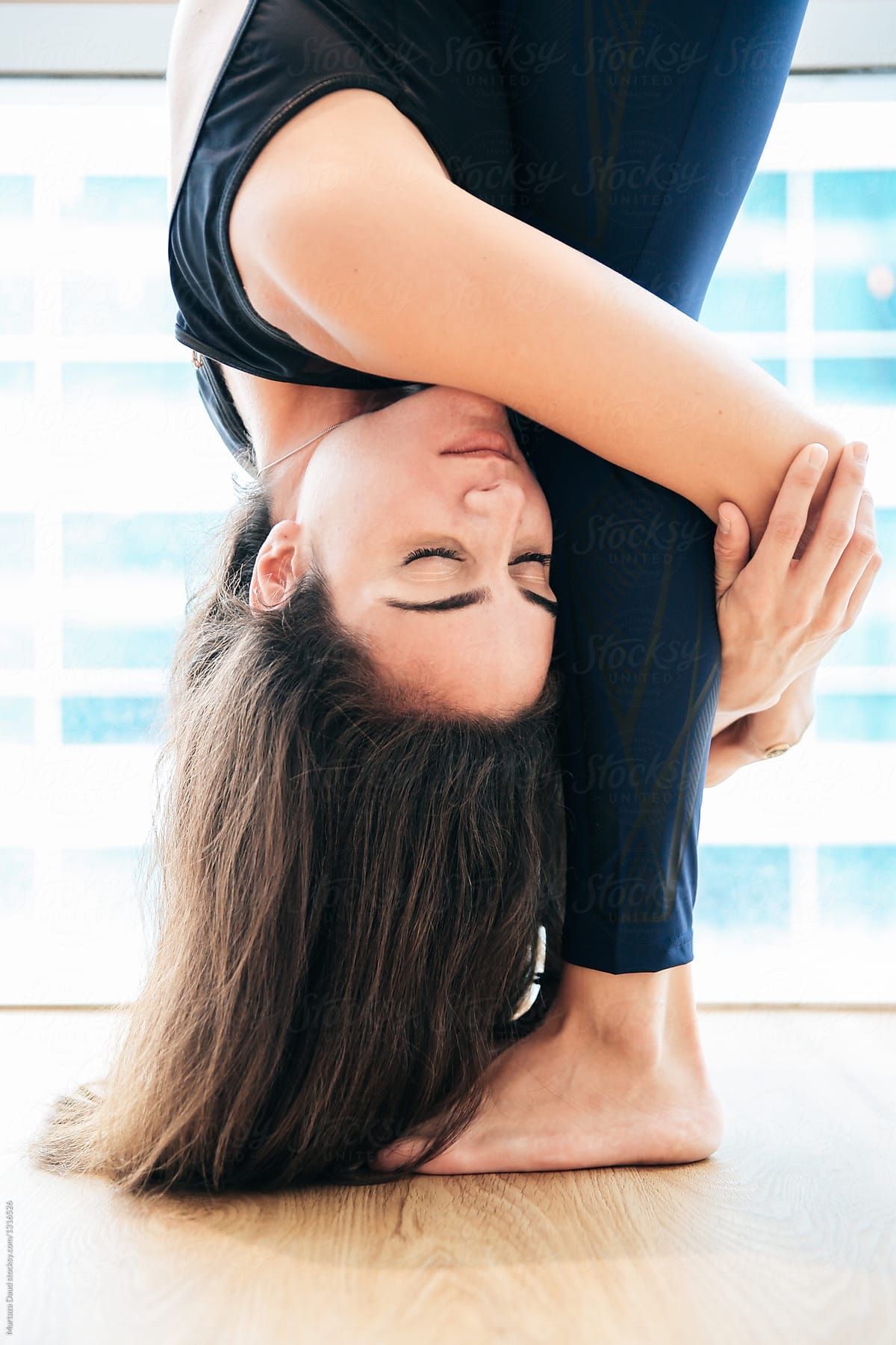 A Yoga Trainer In A Relaxing Stretch by Stocksy Contributor