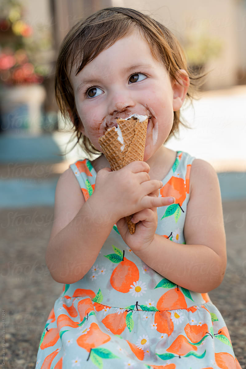 UGC, Happy little girl eating ice cream with dirty face in summer