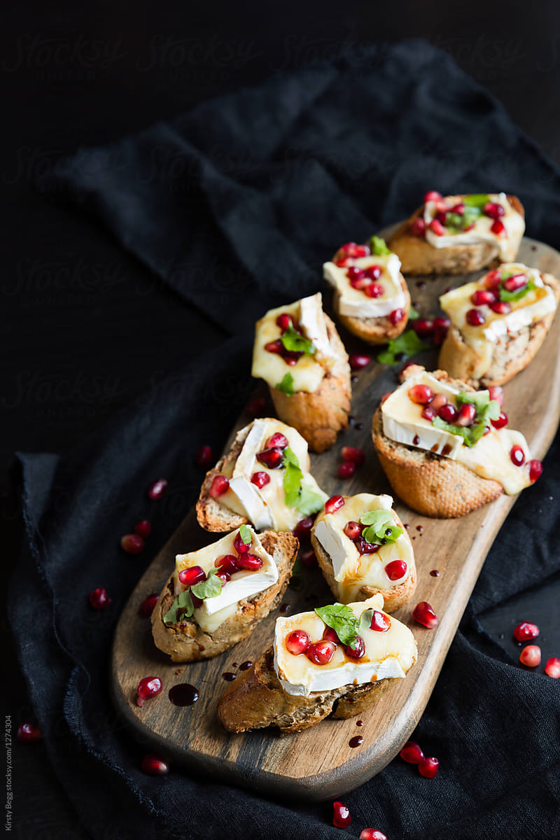 Tasty canape or starter of brie and pomegranate crostini