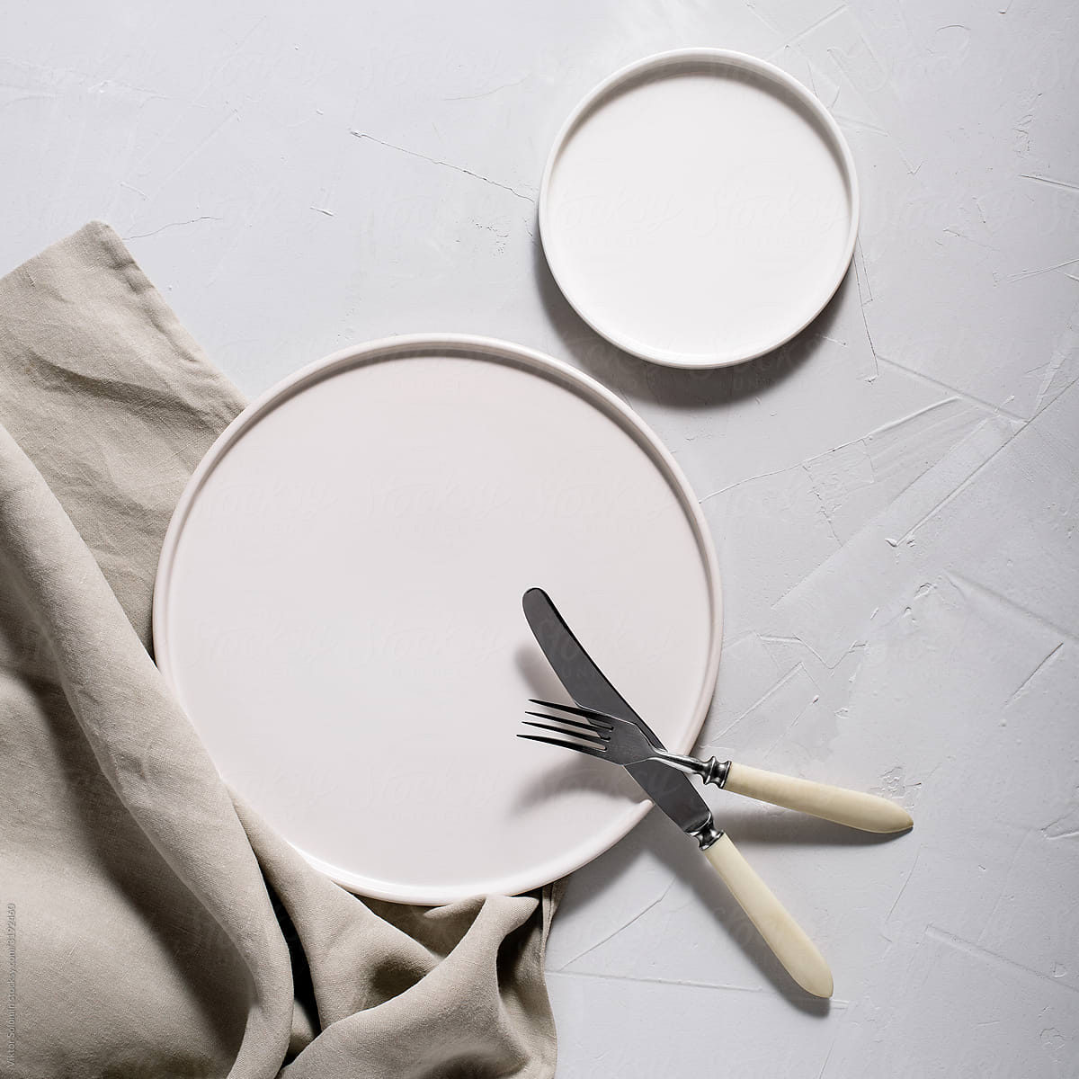 White background round plate, fork, knife and napkin