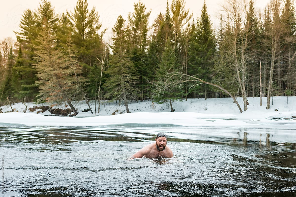 Man Swimming In Ice Cold Frozen Winter River