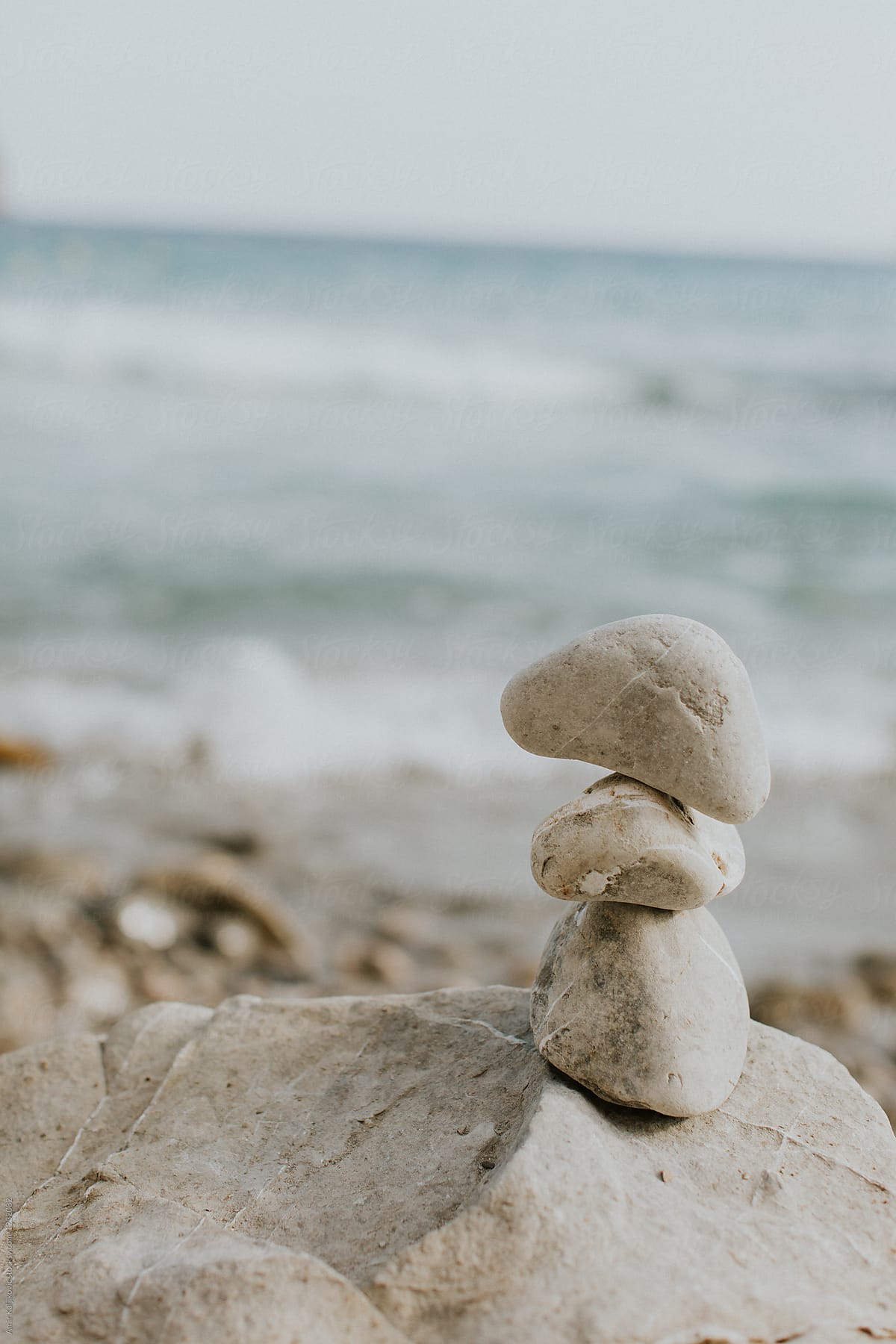 Three smooth water rocks stacked in a cairn