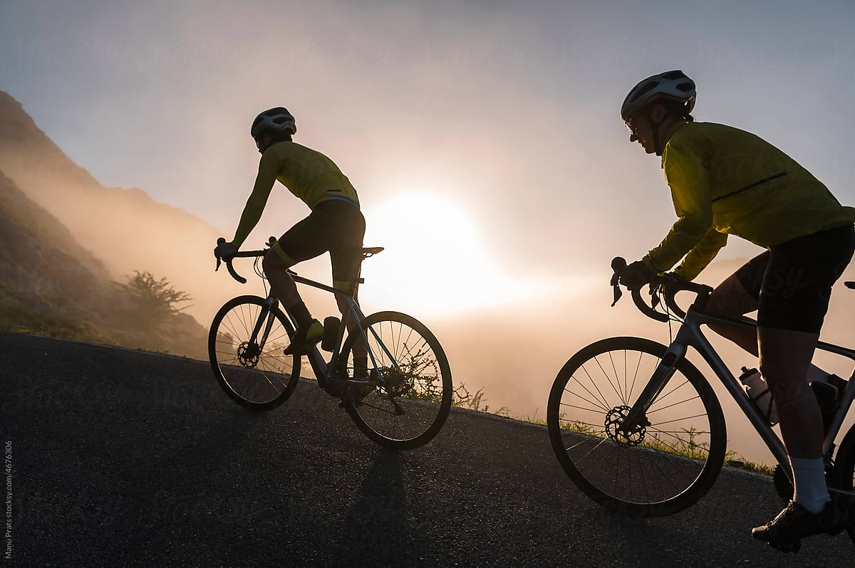 Sporty couple cycling on misty morning
