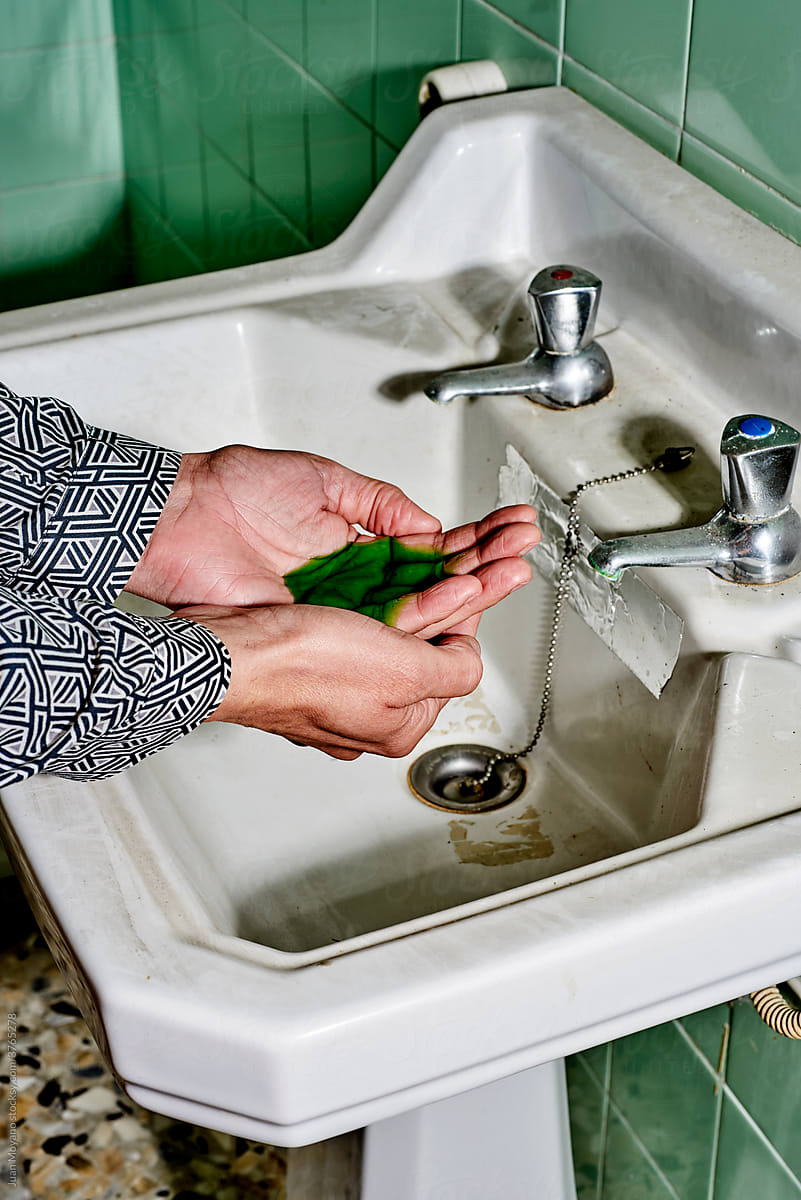 washing hands in an old bathroom
