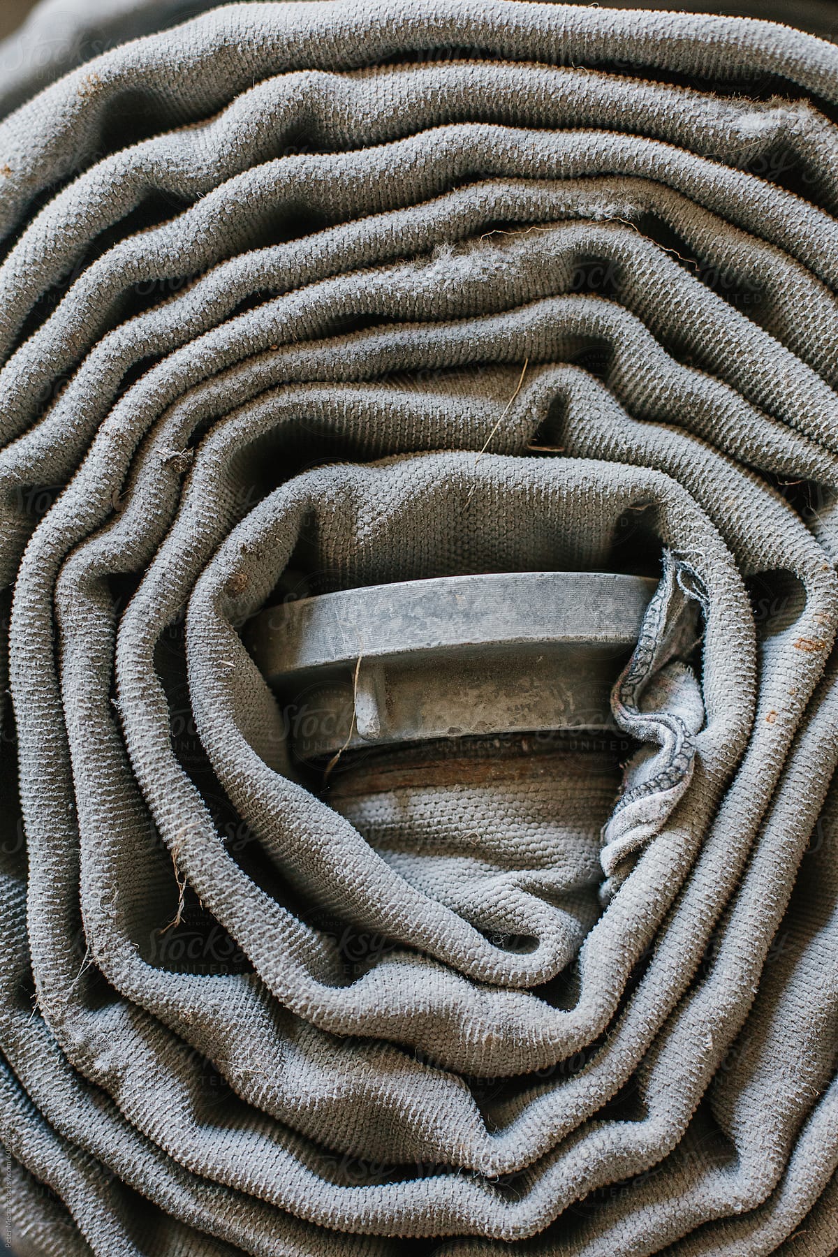 Wrapped old fire hoses on the floor