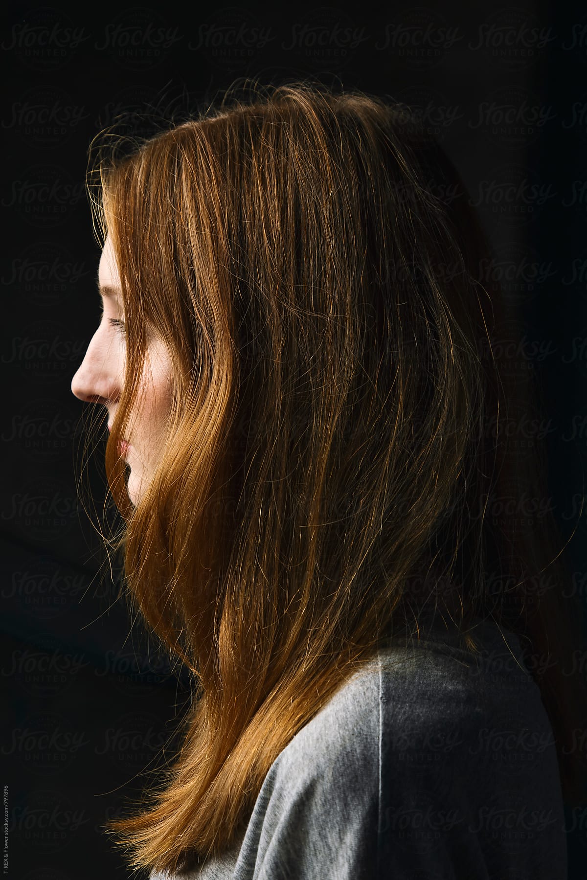 Side view of redheaded young woman