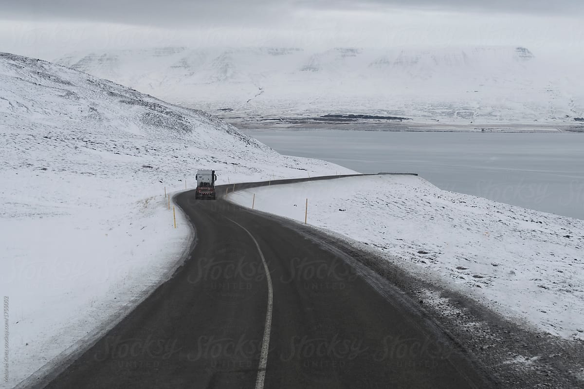 Truck on a winding road to a fjord in winter