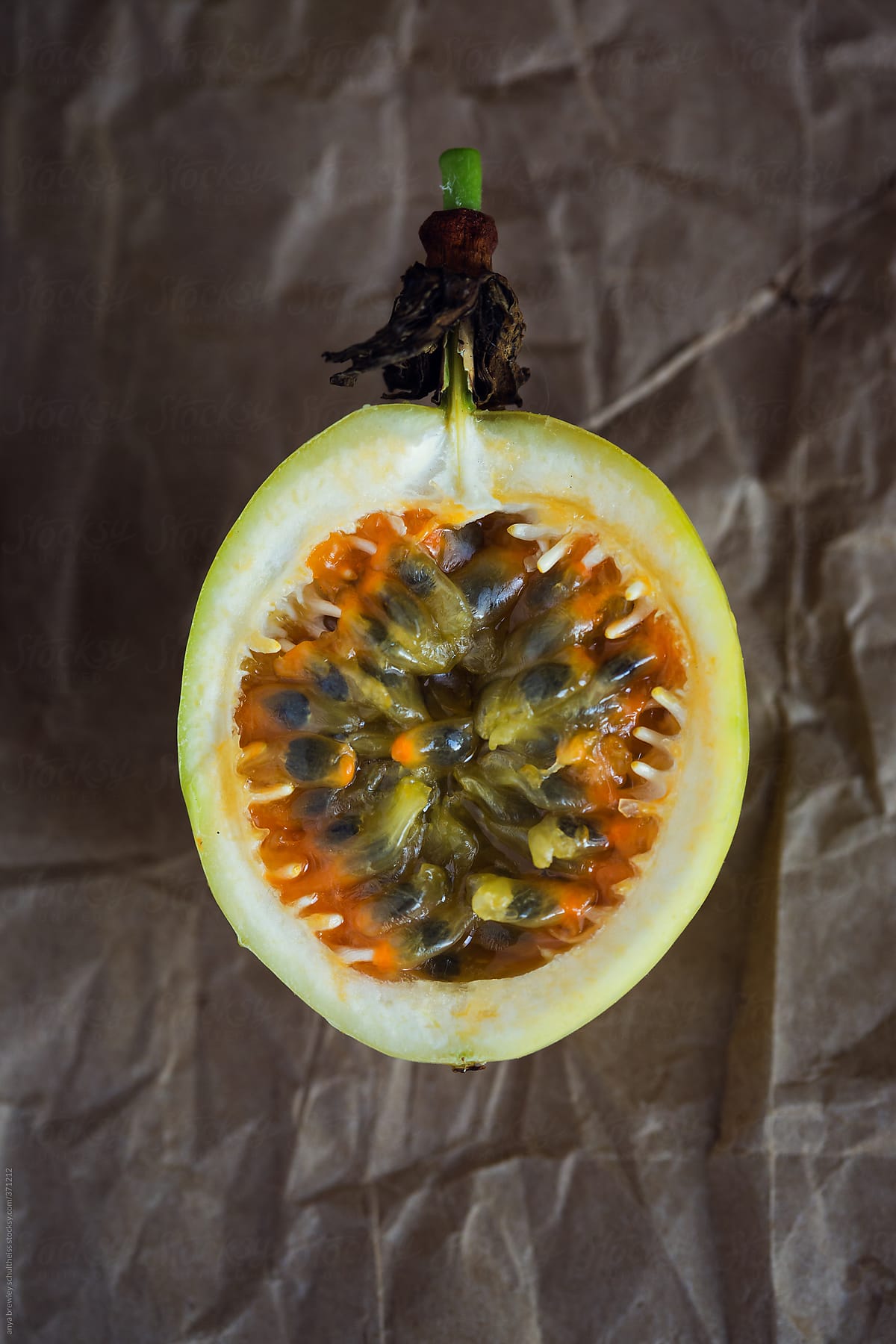 Cut passion fruit showing the inside seeds and pulp
