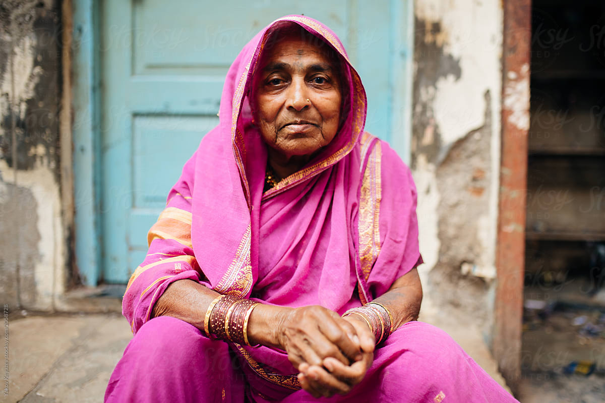aged Indian female posing by her door