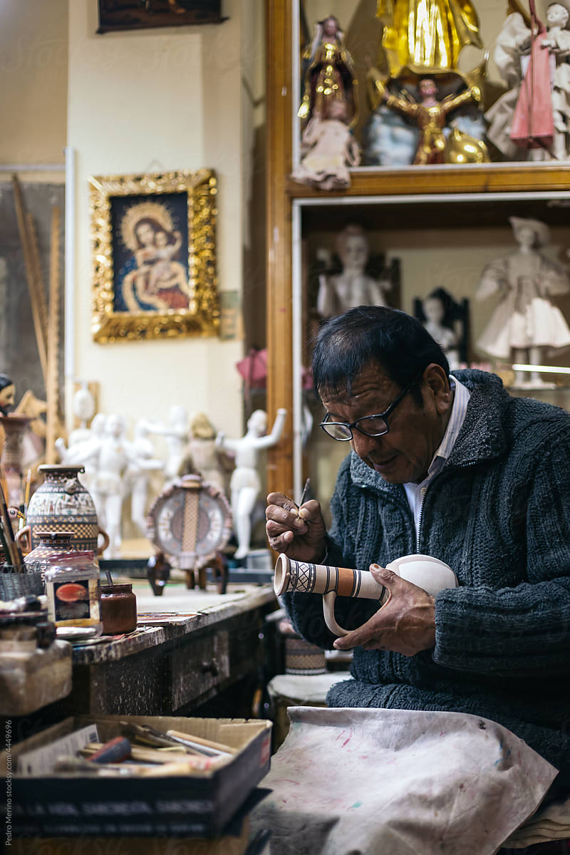 Senior ceramic artist working in his workshop