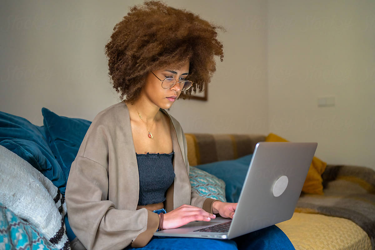 Young Woman With Glasses Working From Home With Laptop.