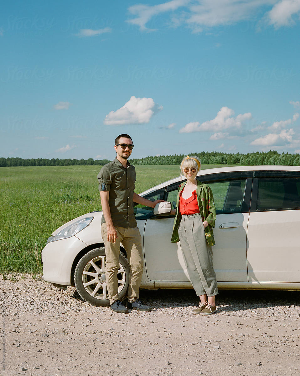 Young stylish couple near his white car