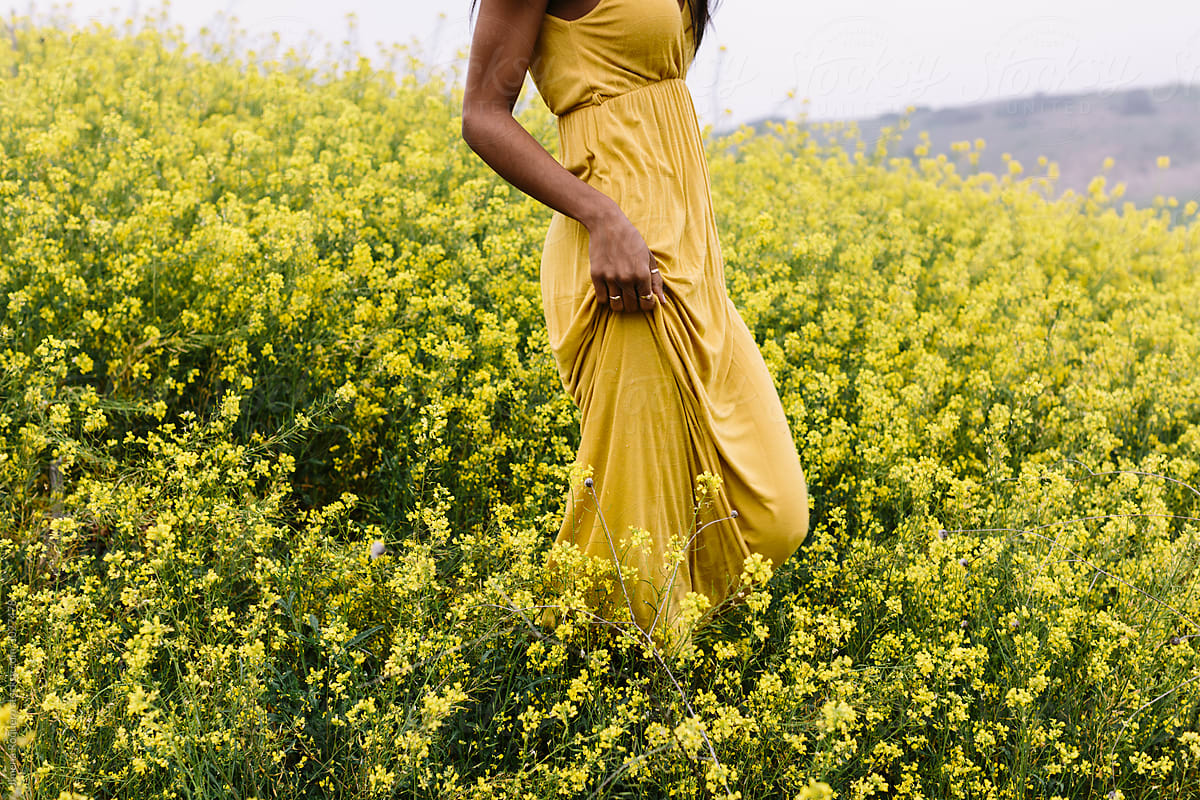 Woman body in yellow in a flowery land
