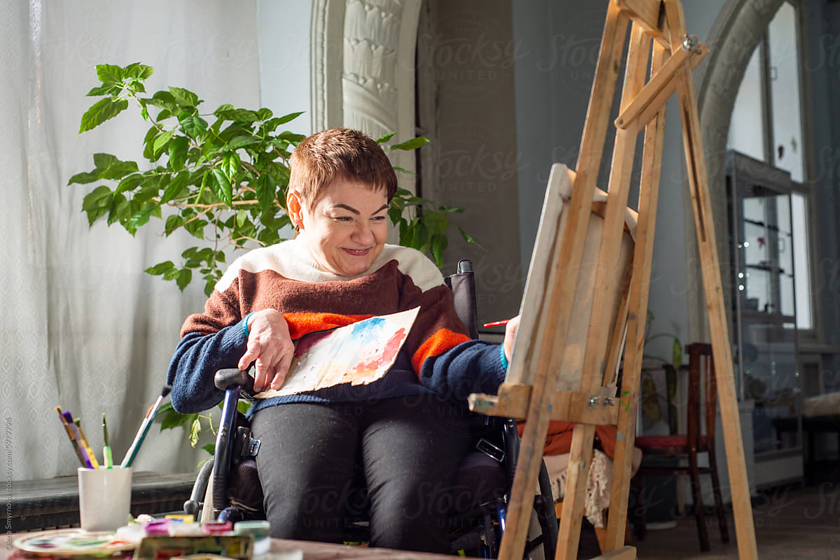 Artist in a wheelchair paints a picture
