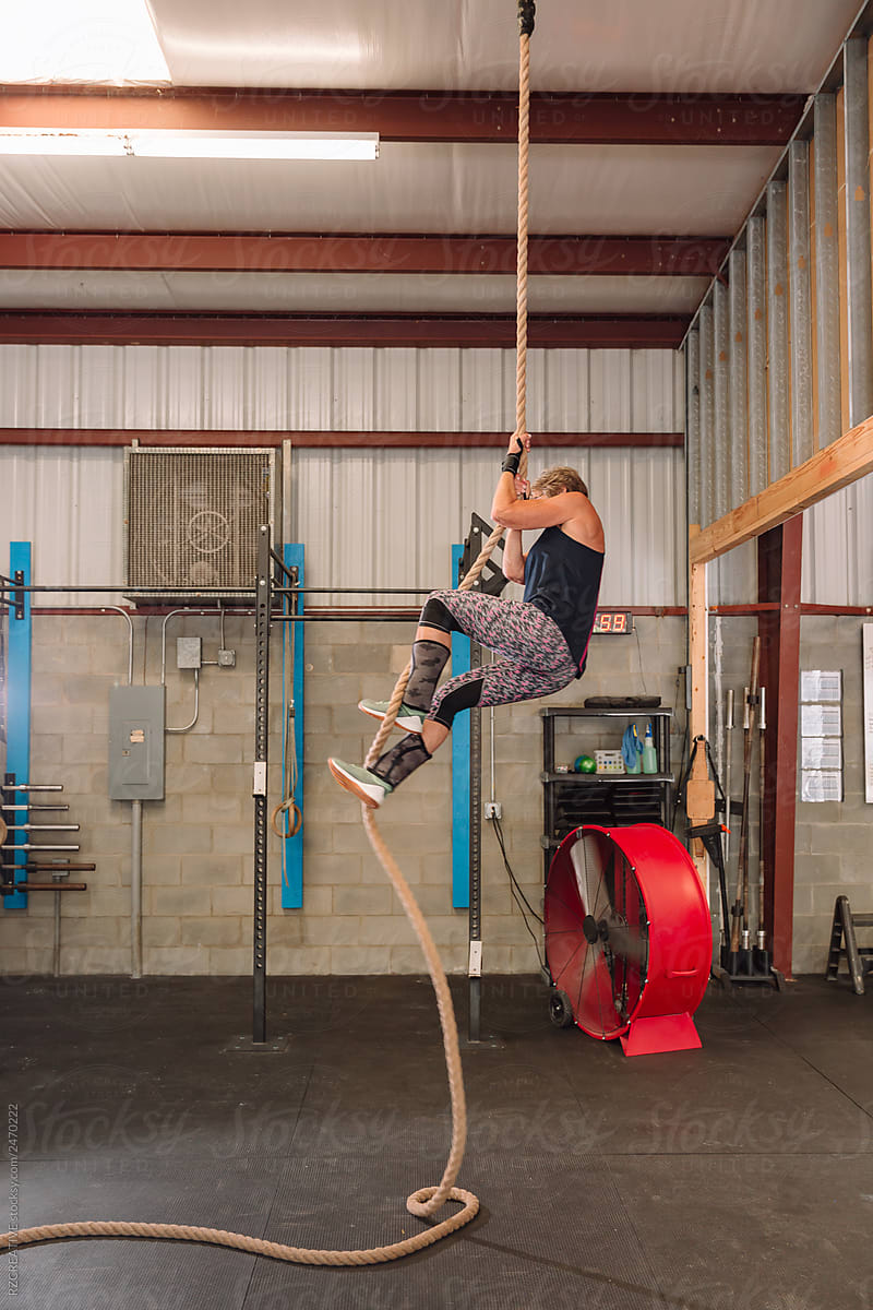 Senior Woman Climbing Rope At Gym By Stocksy Contributor Rzcreative