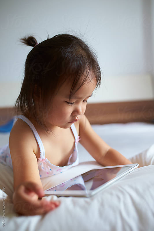 Little girl using tablet indoor