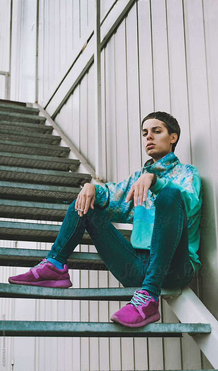 Young adolescents in colorful  track suits from 90\'s in east Europe projects.