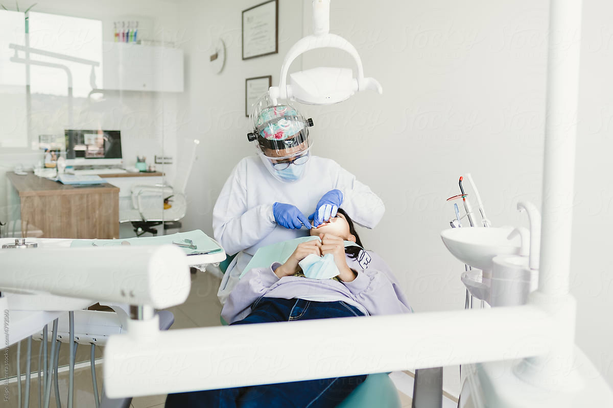 Female dentists during a dental intervention with a patient