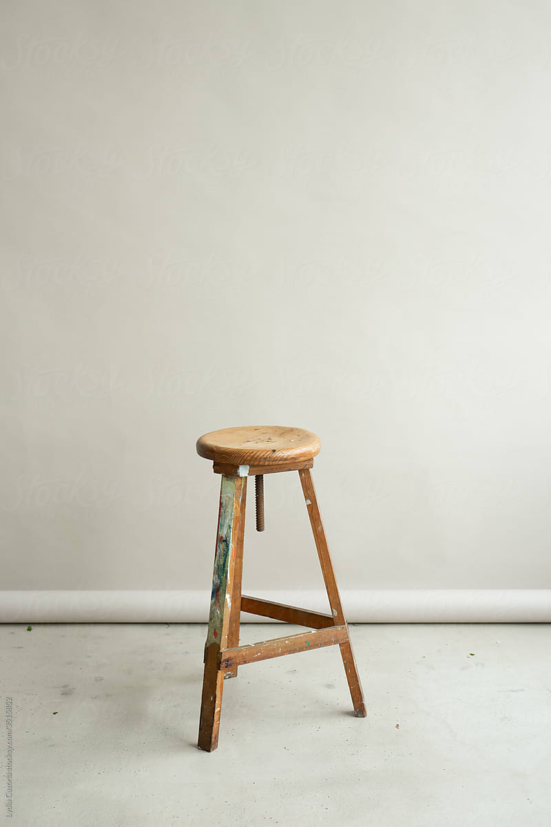 Old stool on gray studio paper roll backdrop