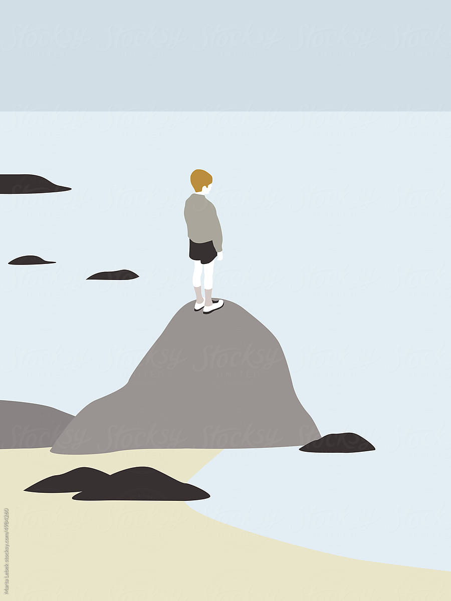 Boy standing on a rock