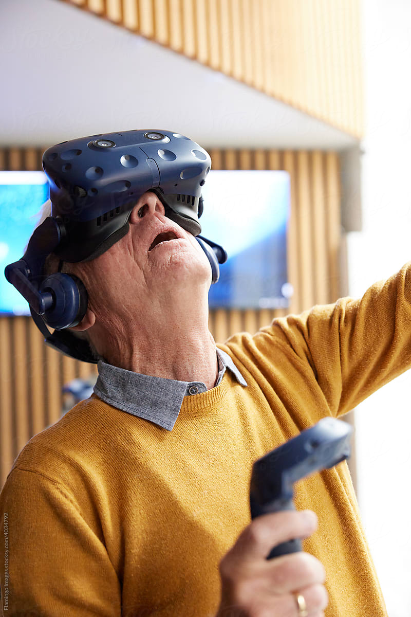 Senior man exploring a virtual world at a vr club