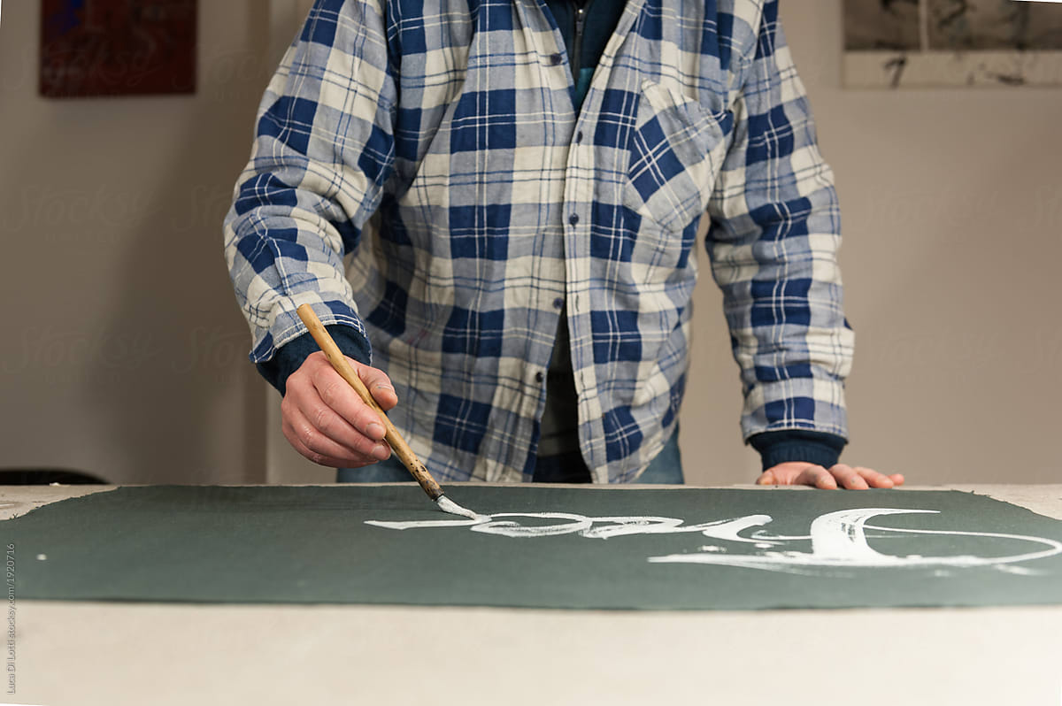 A Master Calligrapher writing using a special paintbrush