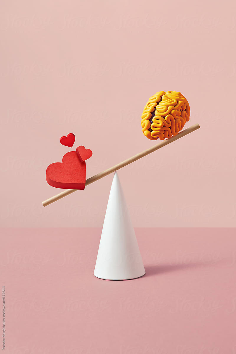 Heart and brain balancing on wooden stick